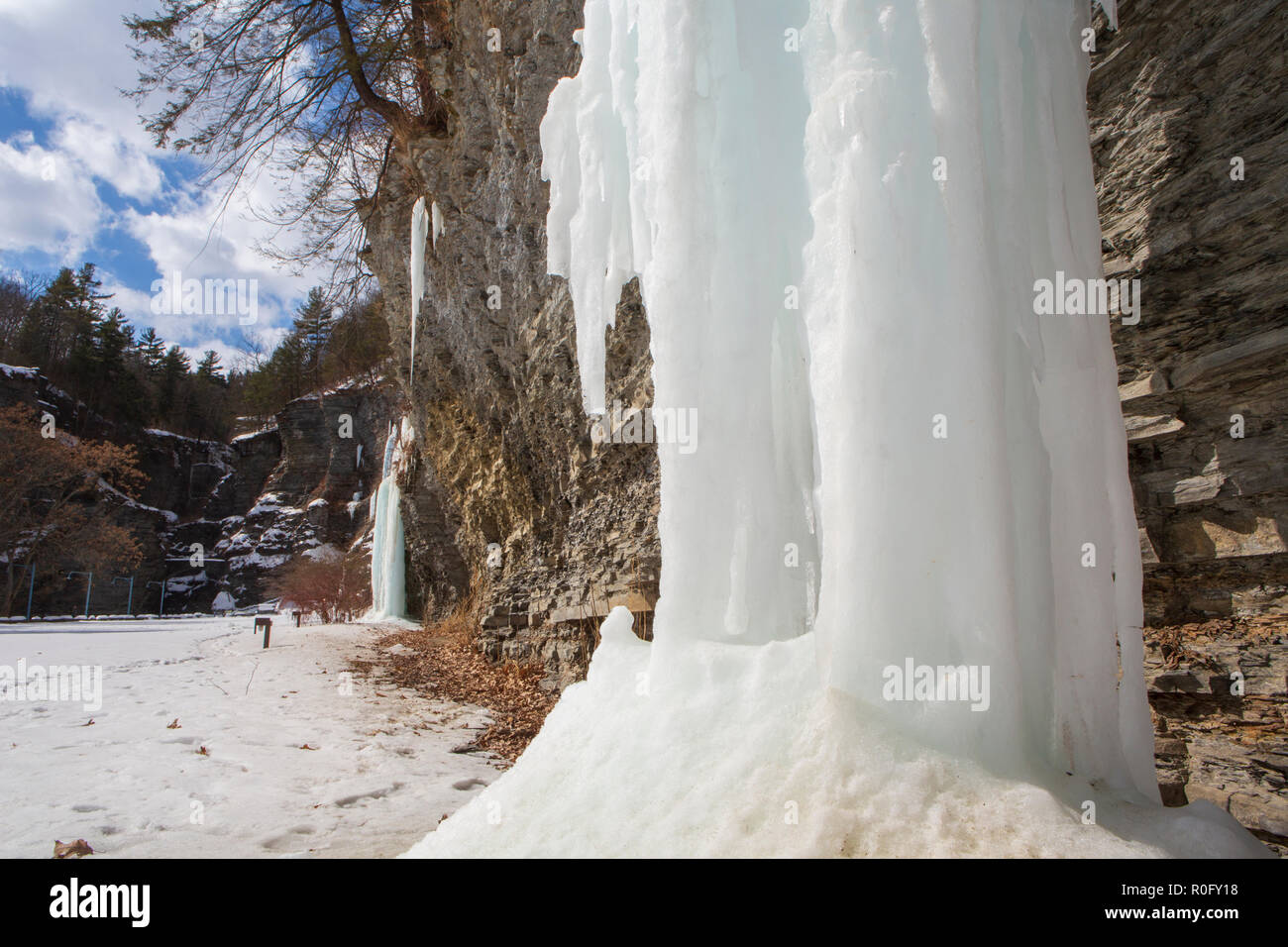 Frozen waterfalls appear on a cliff at Watkins Glen State Park, Watkins Glen, in New York State during a sunny, but cold winter day. Stock Photo