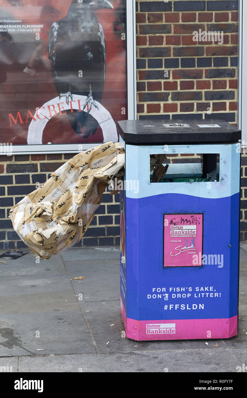 'for fish sake don't drop litter', City of London Trash can with a cardboard box shoved in it Stock Photo