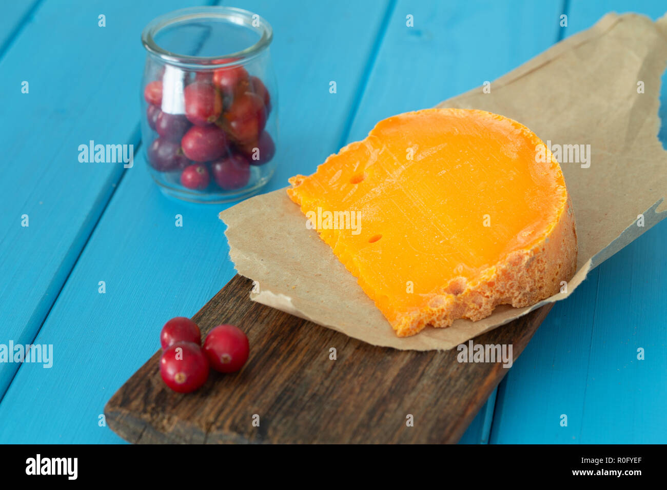 Mimolette,  type of cheese together with the addition of bread, fresh cranberries Stock Photo