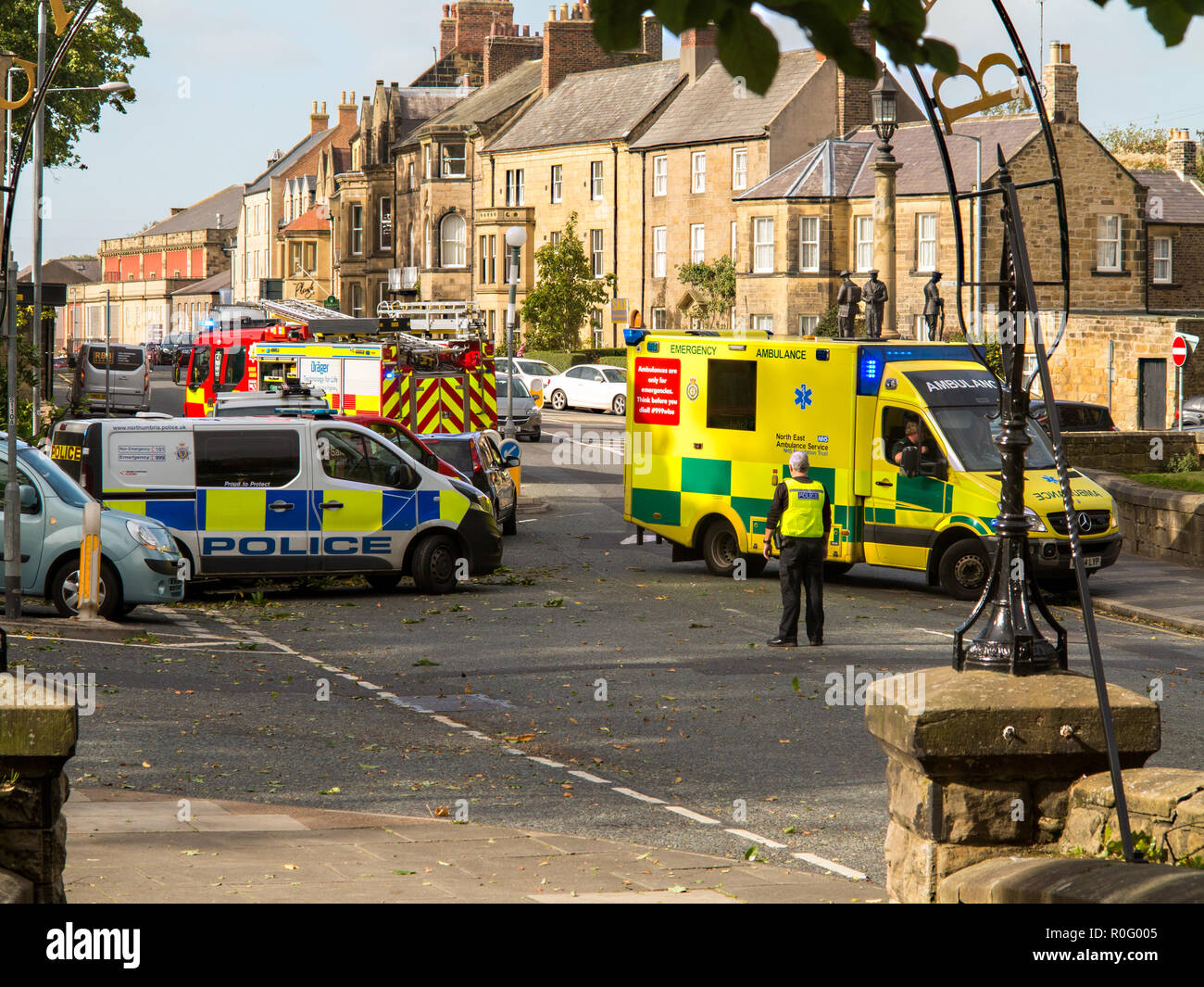 Emergency services fire police and ambulance paramedics attend a road traffic accident  at Alnwick Northumberland England UK Stock Photo
