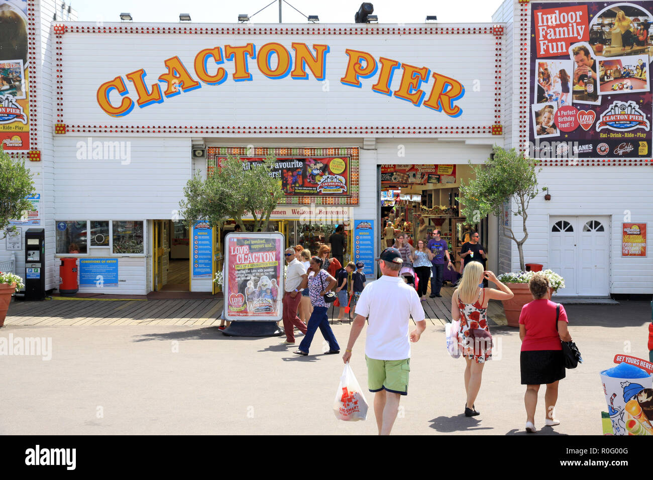 Holidaymakers on holiday coming out of and going into Clacton Pier at the traditional  English holiday resort of Clacton in Essex England UK Stock Photo