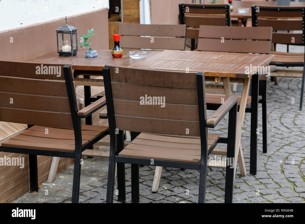 Cozy street restaurant, Tables and chairs in the street Stock Photo - Alamy