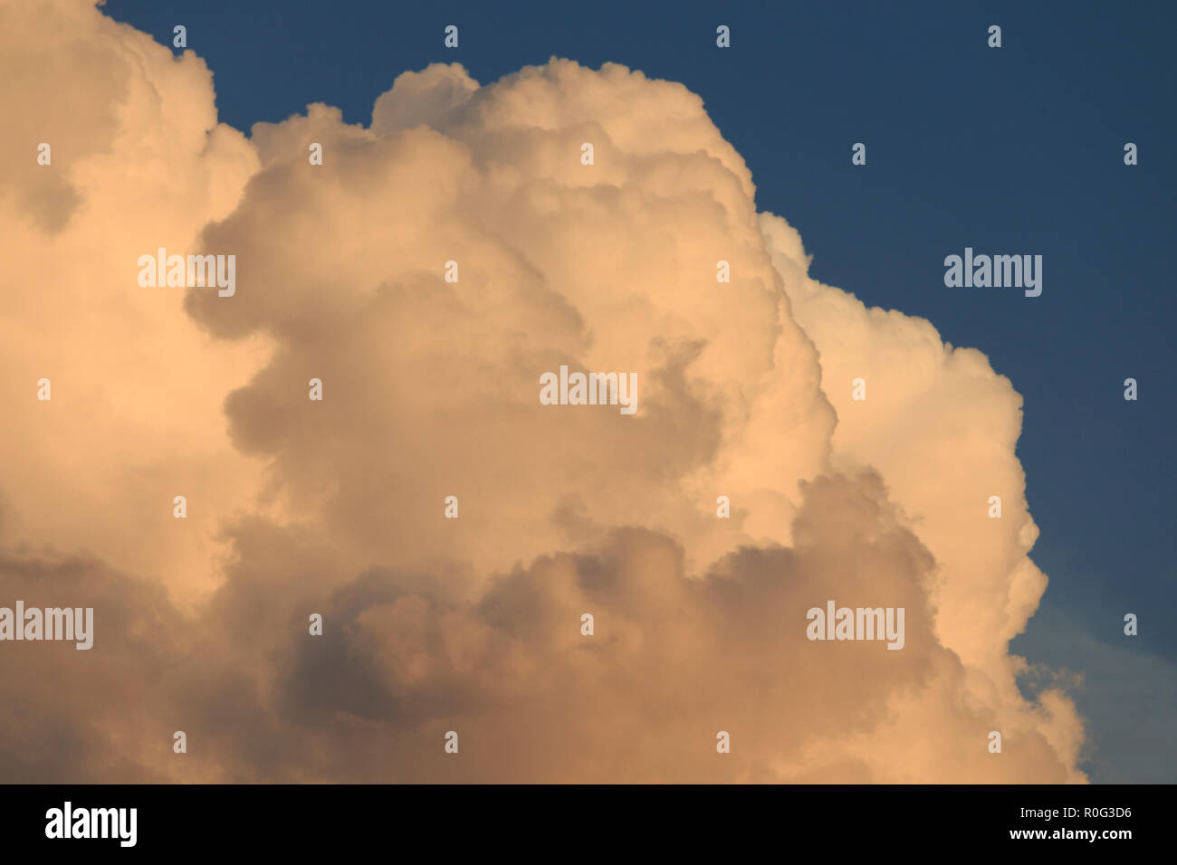 Evening summer clouds closeup. Captured by using zoom lens at golden hour sunset time. Stock Photo