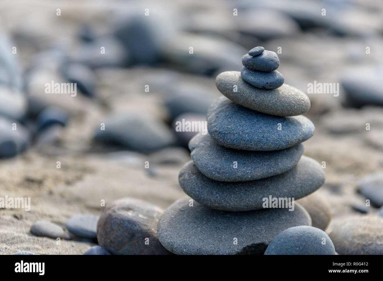 Balance Rocks Ocean Balance and wellness concept. Close-up of ocean stones balanced on ...