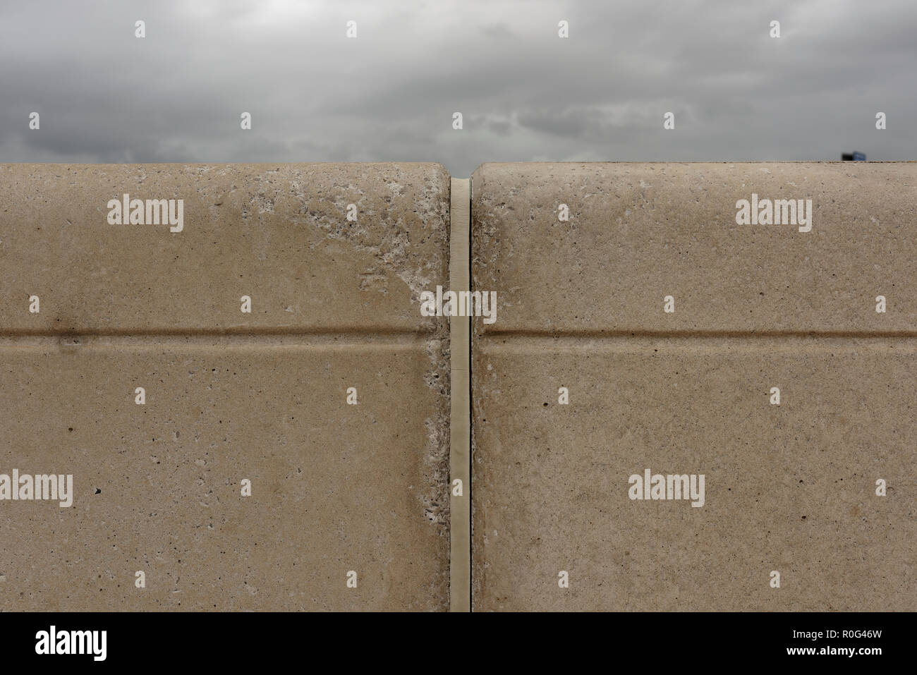 Precast concrete flood wall panels with expansion joint and sealer, on