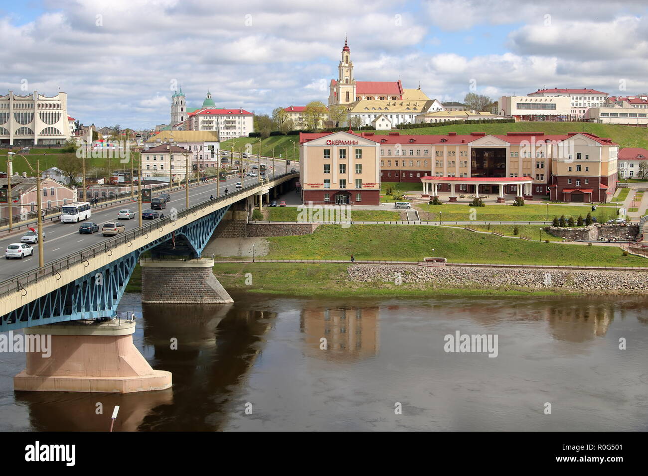 Cityscape of Grodno, Belarus, Polish city in past time, river Niemen, bridge, buildings, cloudy sky. Stock Photo