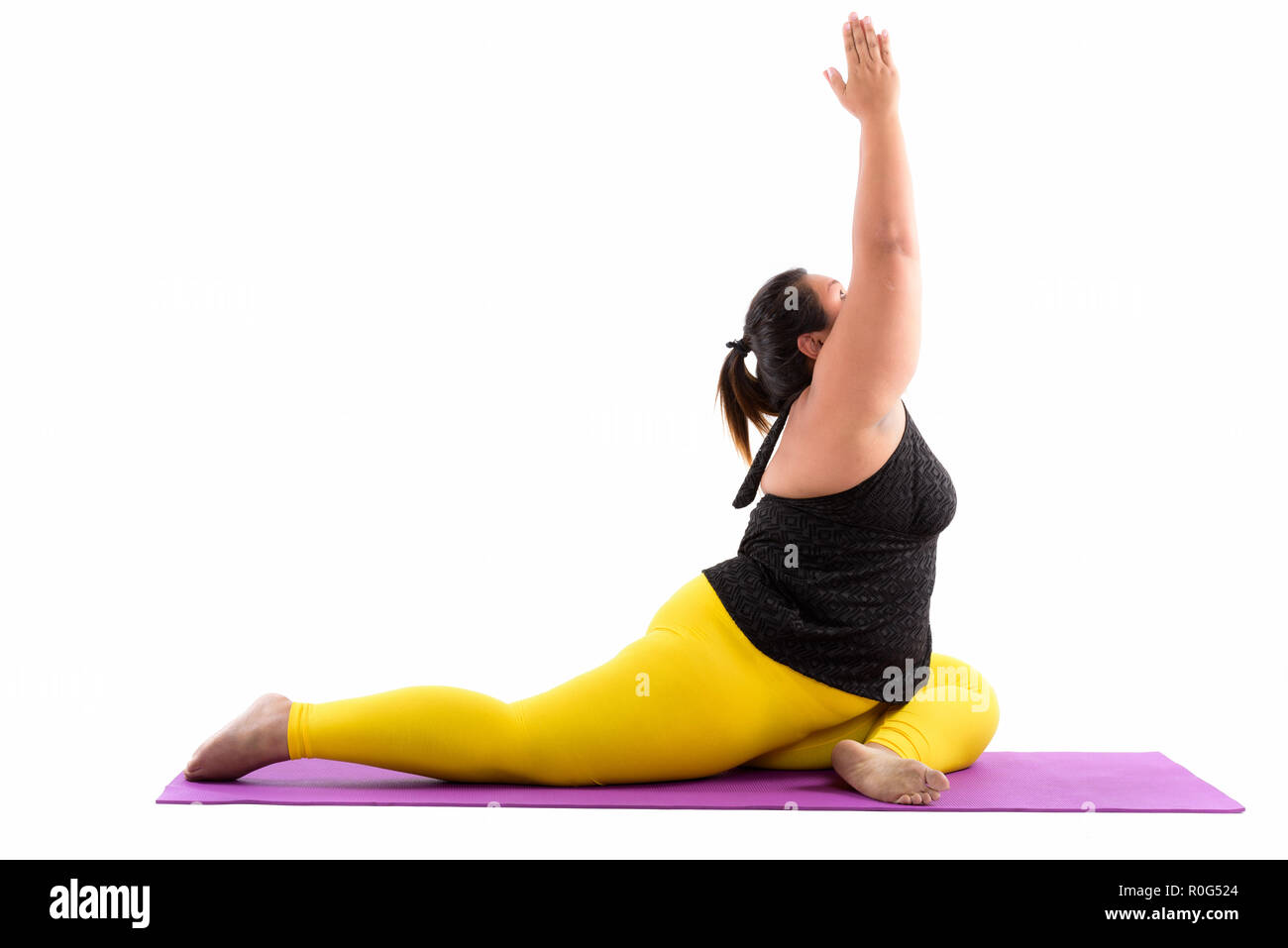Studio shot of young fat Asian woman stretching her legs and rea Stock Photo