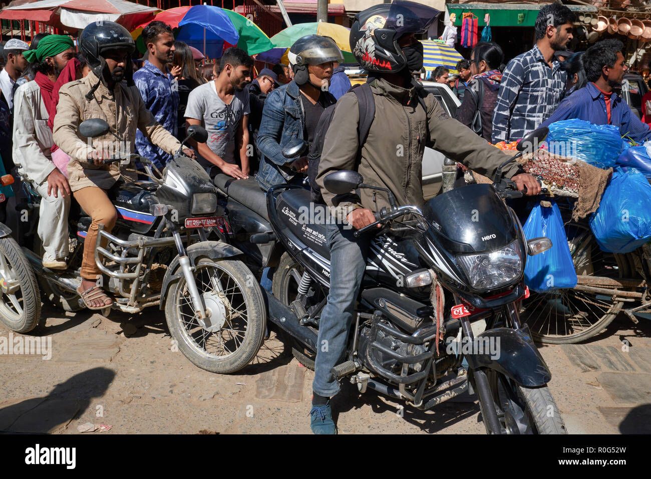 A lane in a market area in Kathmandu, Nepal, is jam-packed with motorcycles and pedestrians, a typical traffic situation for the Nepalese capital Stock Photo