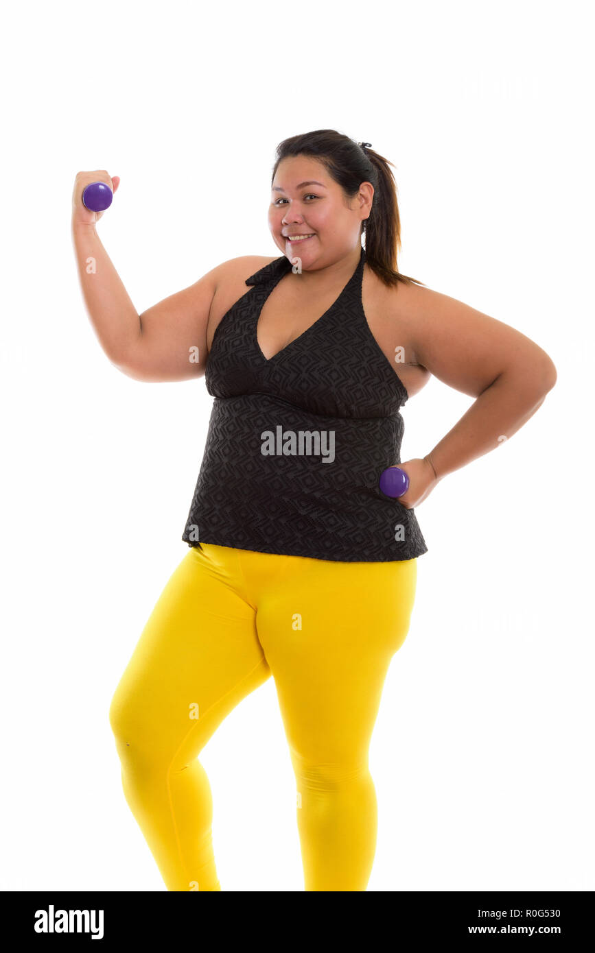 Studio shot of young happy fat Asian woman smiling and standing Stock ...