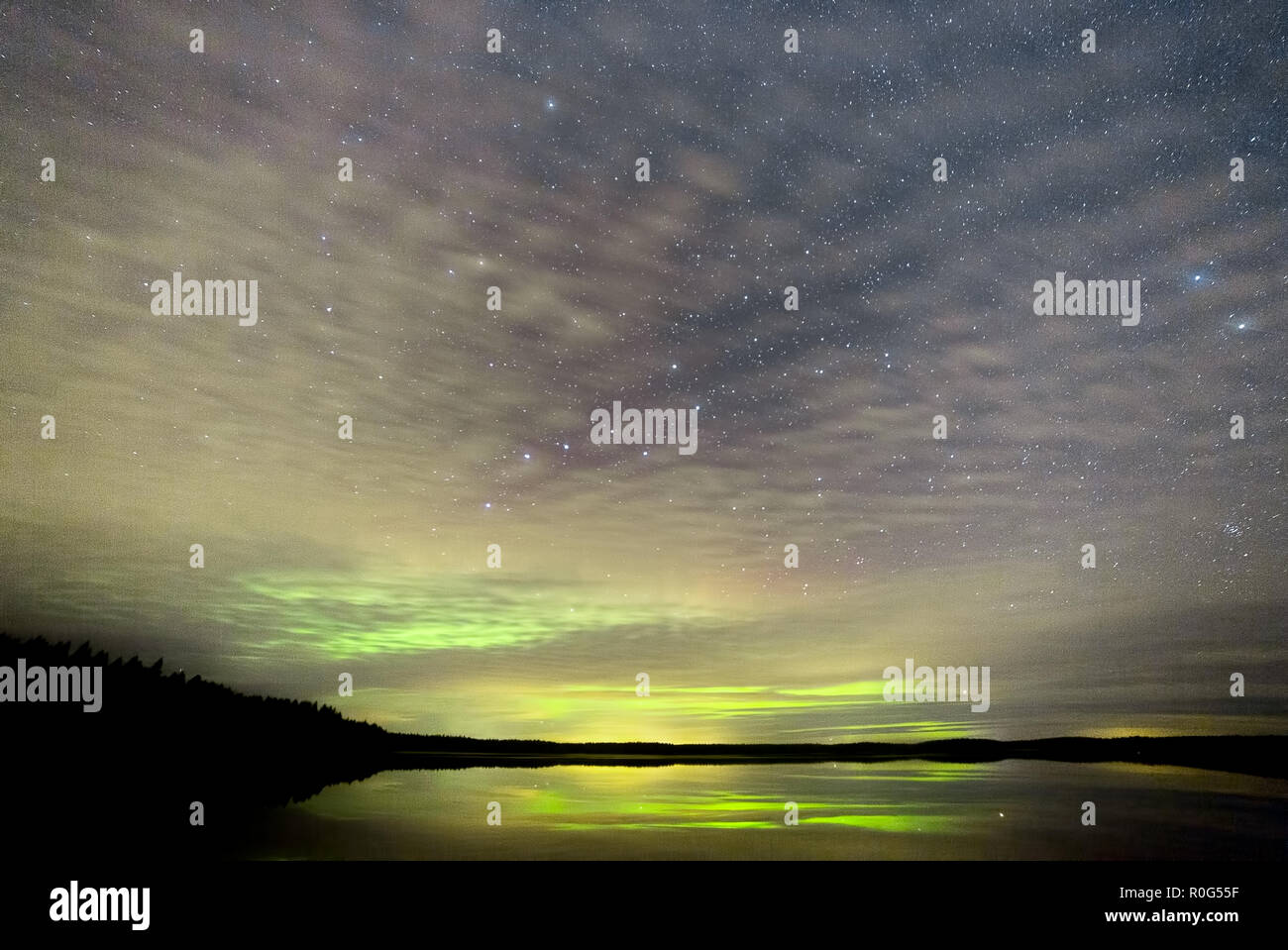 Northern Lights over Lake with clouds and stars Stock Photo - Alamy