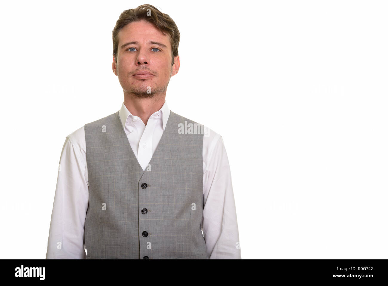 Handsome formal Caucasian man wearing vest and looking at camera Stock Photo