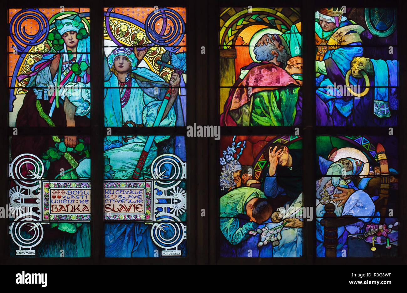 Detail of the stained-glass window designed by Czech Art Nouveau artist Alfons Mucha in Saint Vitus' Cathedral in the Prague Castle in Prague, Czech Republic. The scenes from the life of Saints Cyril and Methodius are depicted in the stained-glass window at the right from top to bottom: Pope John VIII authorizes Saint Methodius to translate the Bible into Slavonic language; the death of Saint Methodius in the Great Moravian Empire. Stock Photo
