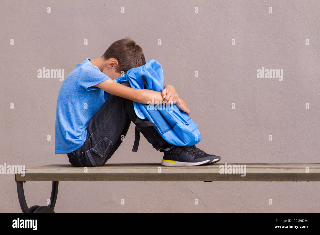 Boy Sitting Head Down Sad High Resolution Stock Photography and Images