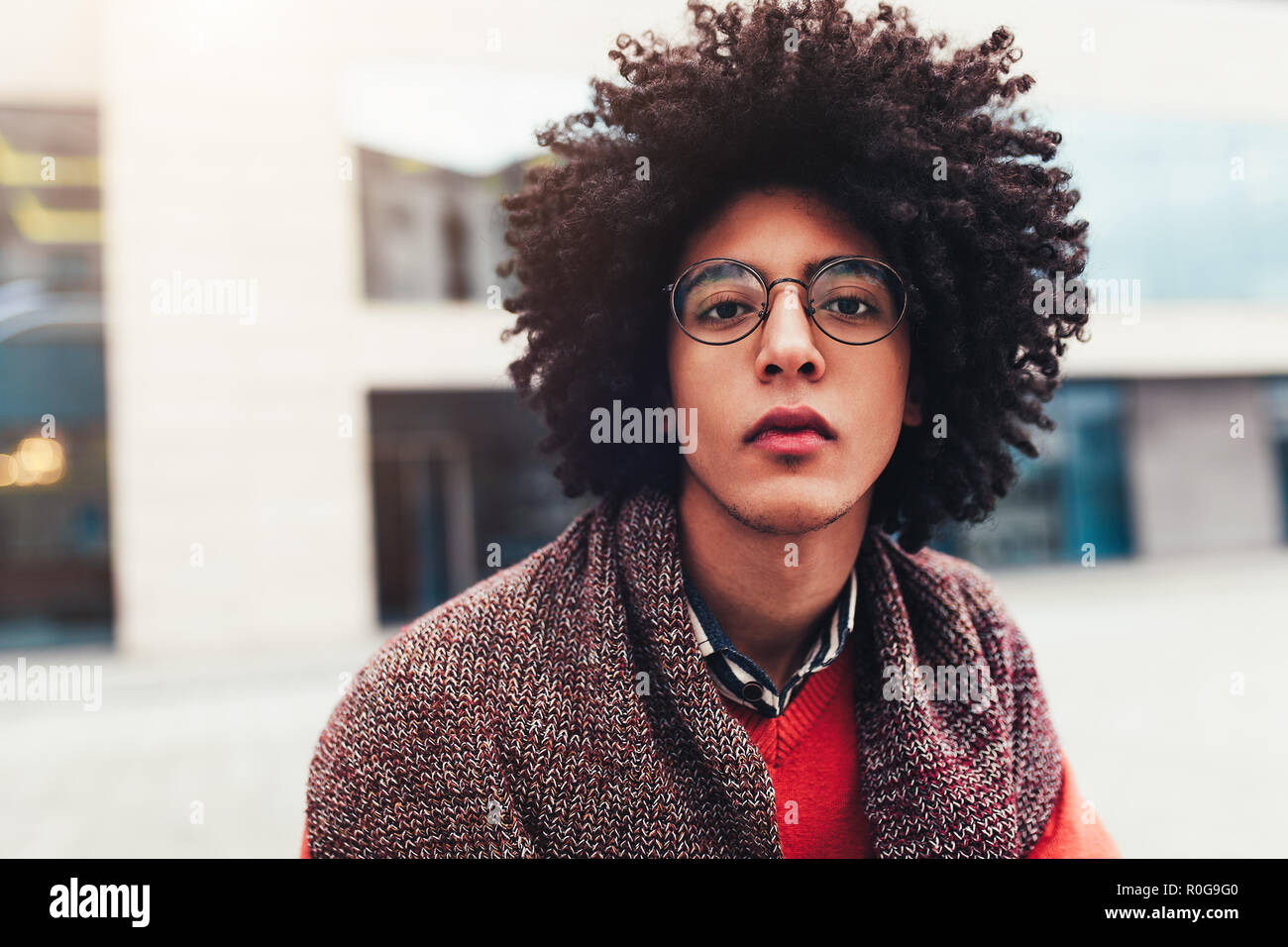 Close-up portrait of a young handsome curly guy. The headshoot of an  Egyptian student. Serious facial expression Eyeglasses Stock Photo - Alamy, image size:1300x956