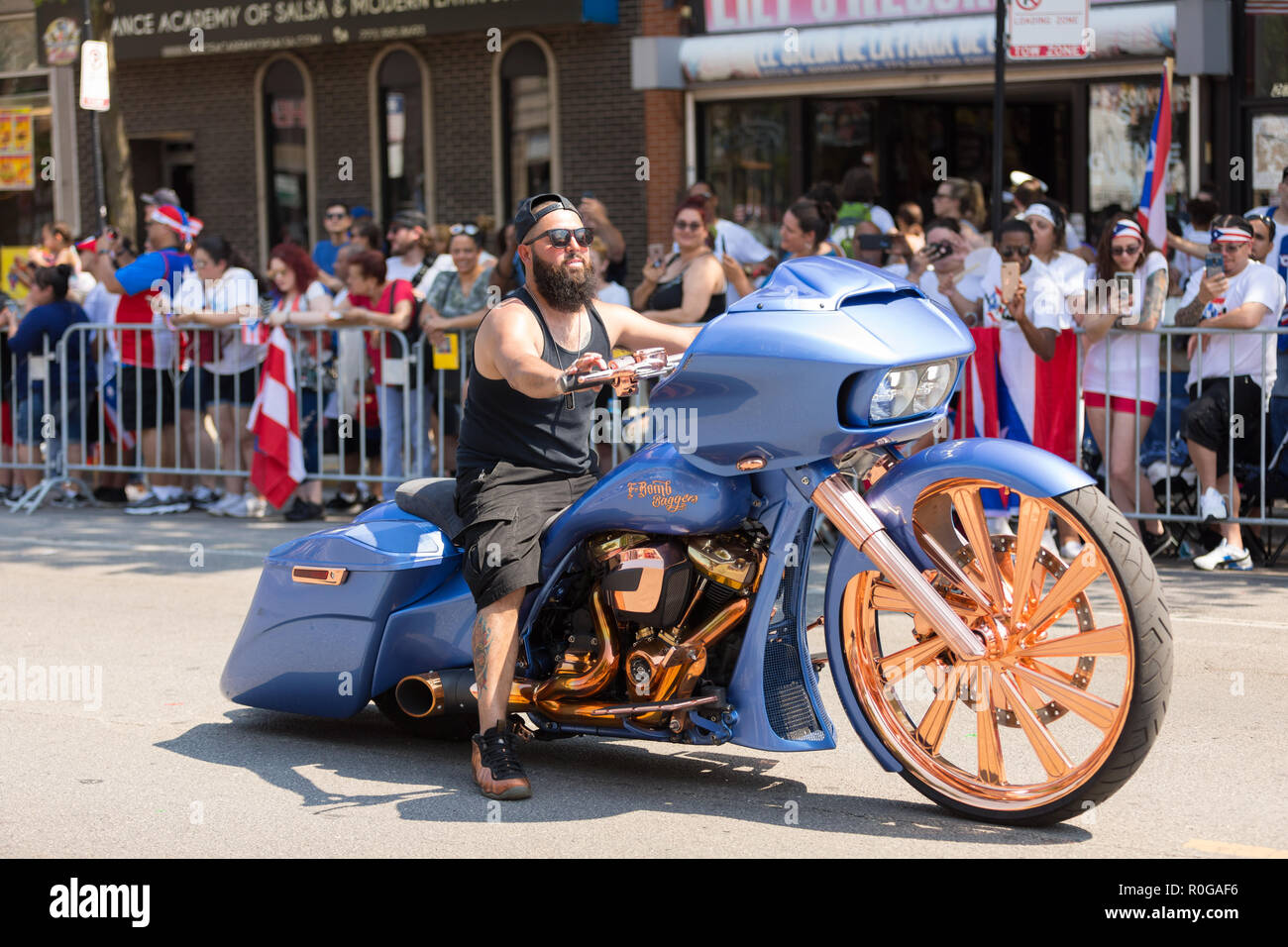 Chicago, Illinois, USA - June 16, 2018: The Puerto Rican People's Parade, Man riding a custom build motorcycle with large wheels and a sticker that sa Stock Photo