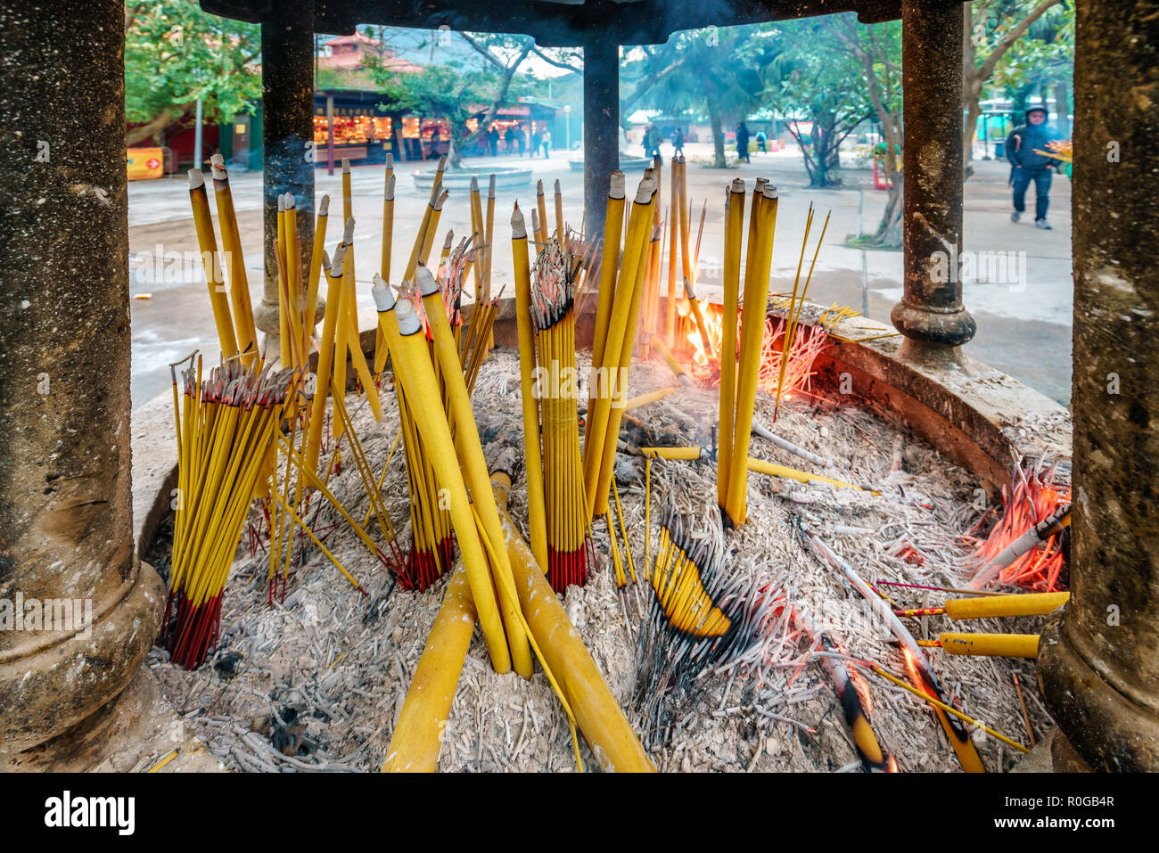 Buddhist prayer sticks burning in the censer in Po Lin Monastery