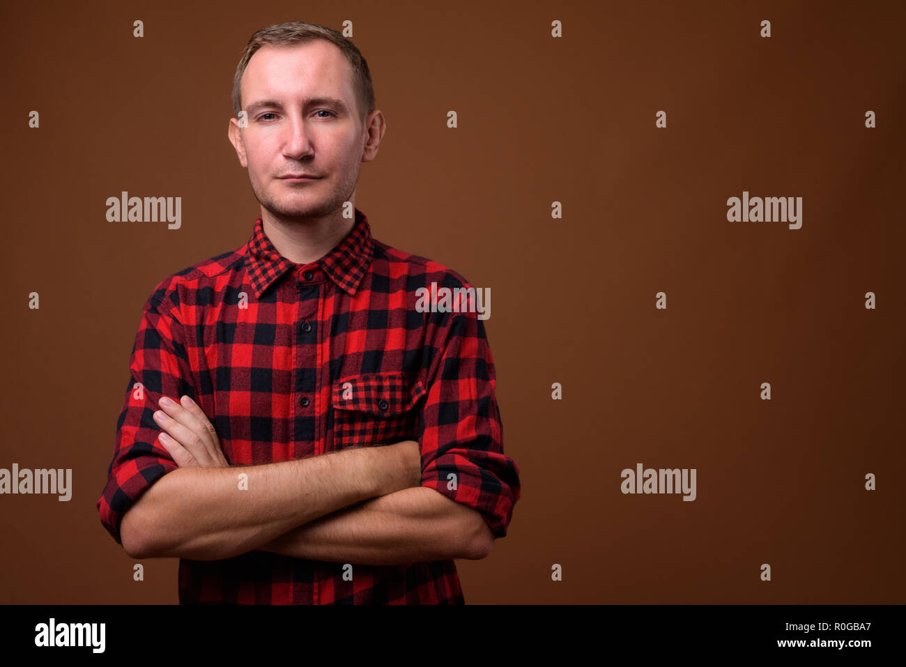 Studio shot of man against brown background Stock Photo