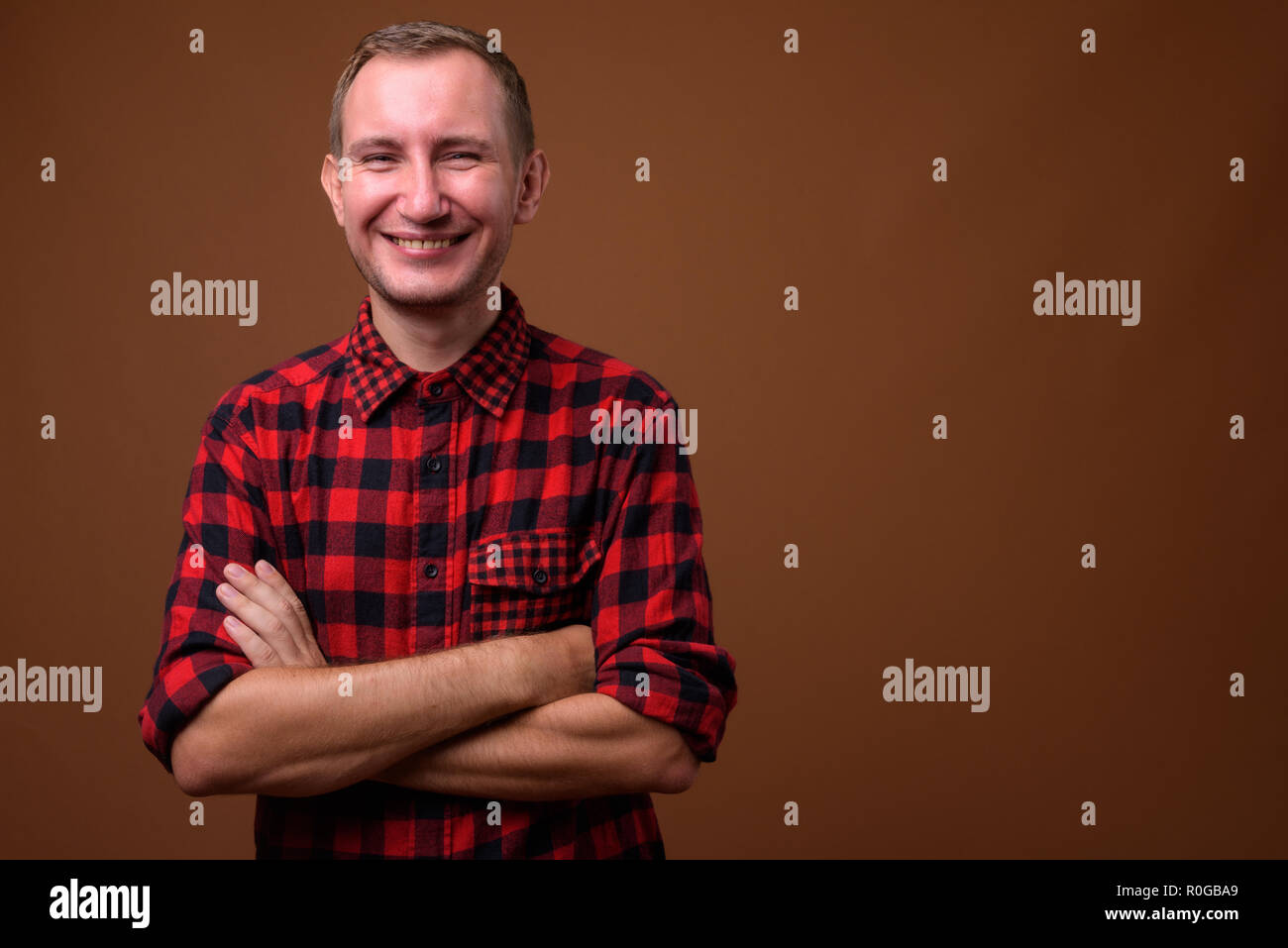 Studio shot of man against brown background Stock Photo