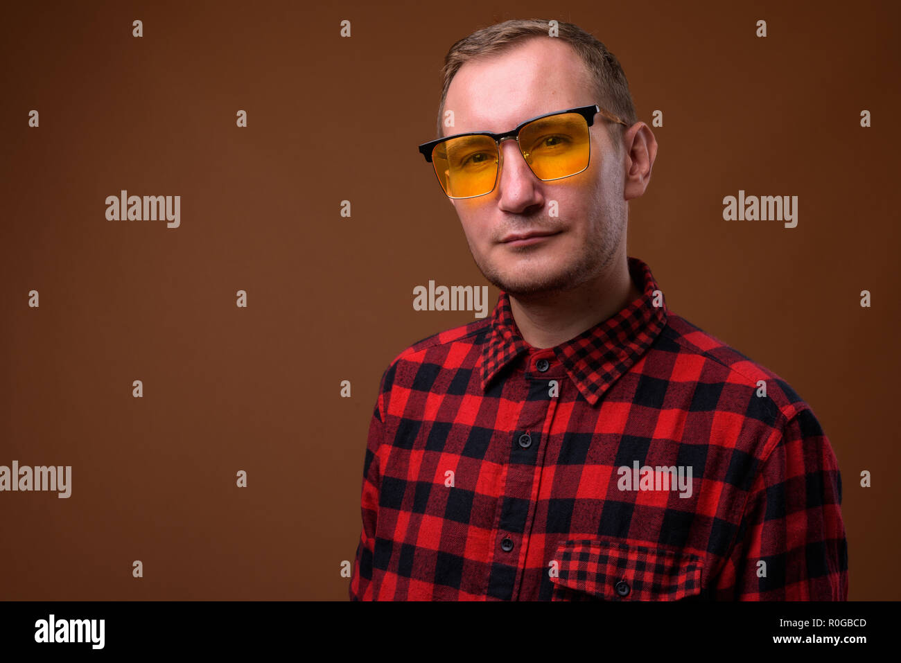 Studio shot of man against brown background Stock Photo