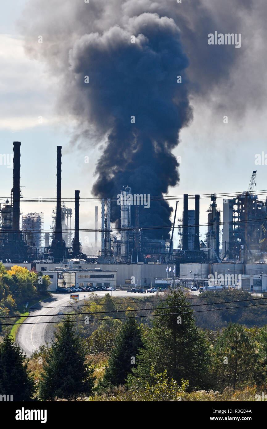A vertical image of an explosion and fire at the Irving Oil Refinery on October 6 2018, in Saint John New Brunswick Canada Stock Photo