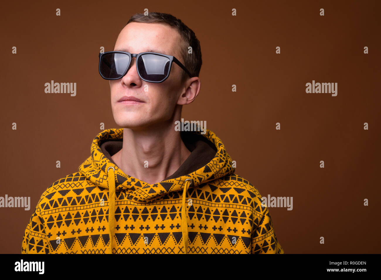 Studio shot of young man against brown background Stock Photo