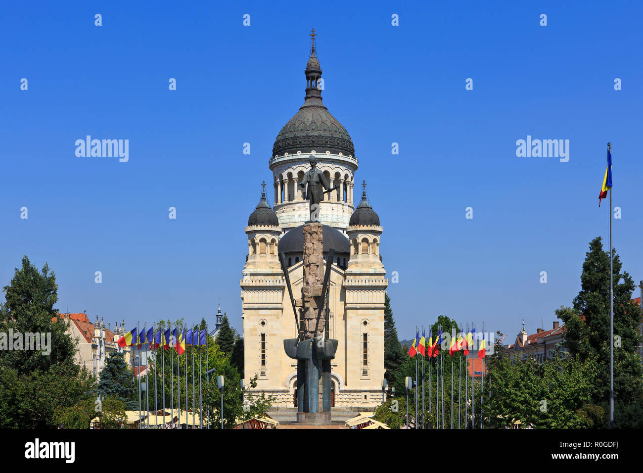 Dormition of the Theotokos Cathedral (1933) and statue of the Transylvanian Romanian lawyer Avram Iancu (1824-1872) in Cluj-Napoca, Romania Stock Photo