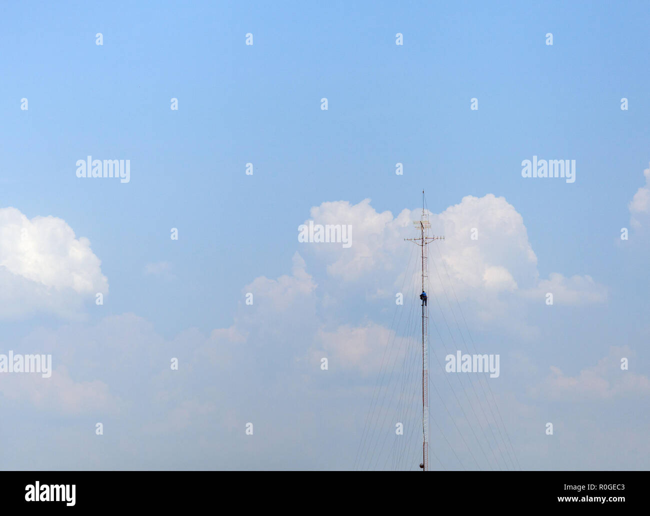 Tower climber and working on cellular tower system. extreme height Stock Photo