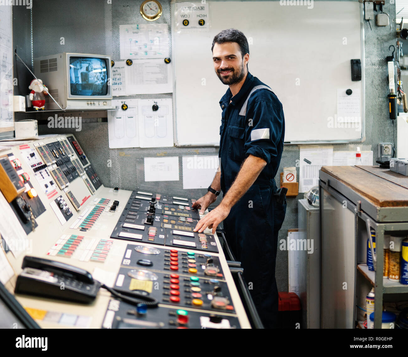 Marine engineer officer working in engine room Stock Photo Alamy