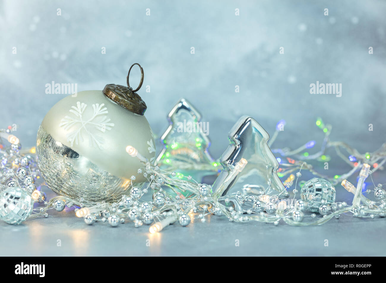 christmas tree decorations, glass ball and fir on frosty blue ...
