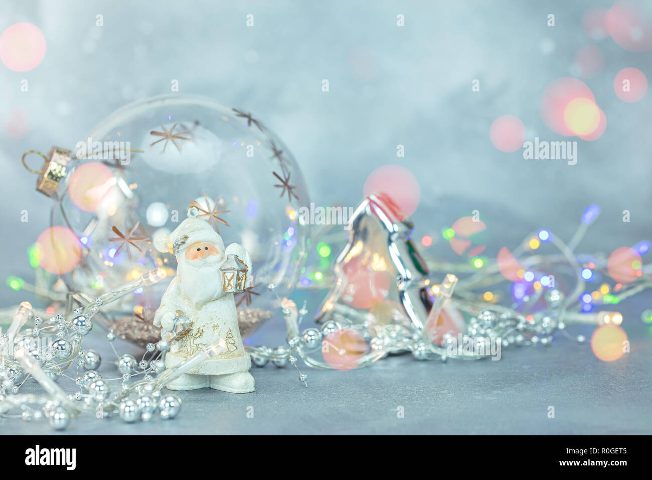 christmas decorations on blue frosty background. glowing light garlands, christmas tree balls and toys Stock Photo