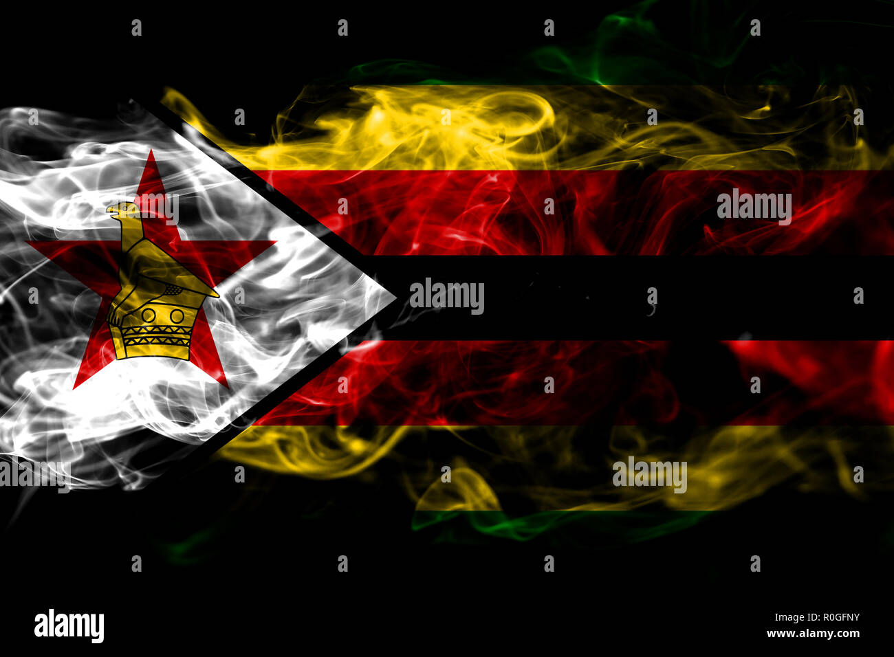 National flag of Zimbabwe made from colored smoke isolated on black