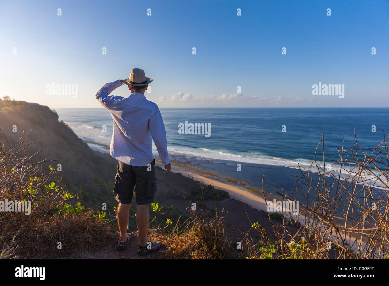 Man stands on a sea cliff Stock Photo