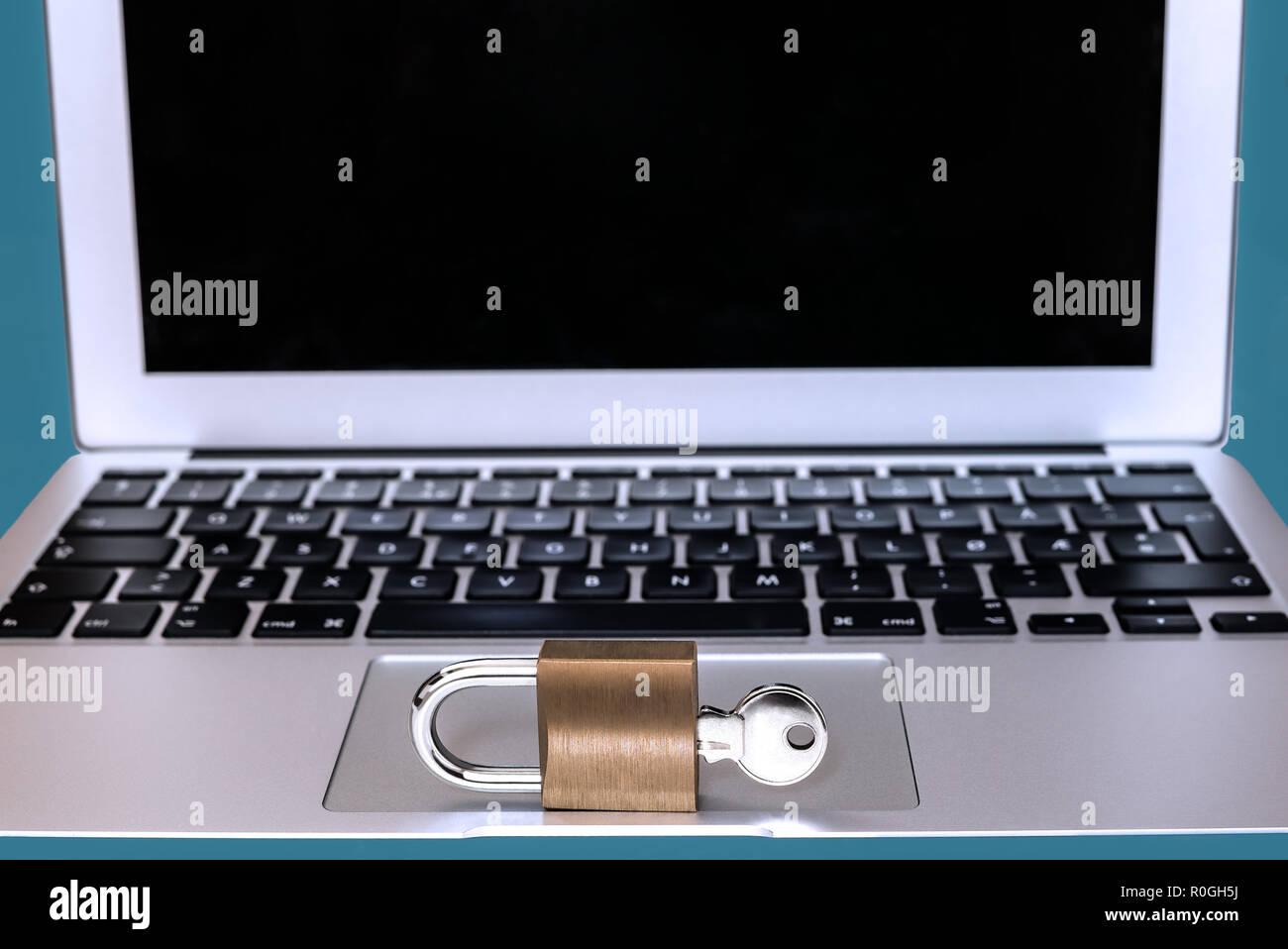 Modern computer with a lock and key in front - Concept of safe online password, web security, private information protection or internet hacker crime  Stock Photo