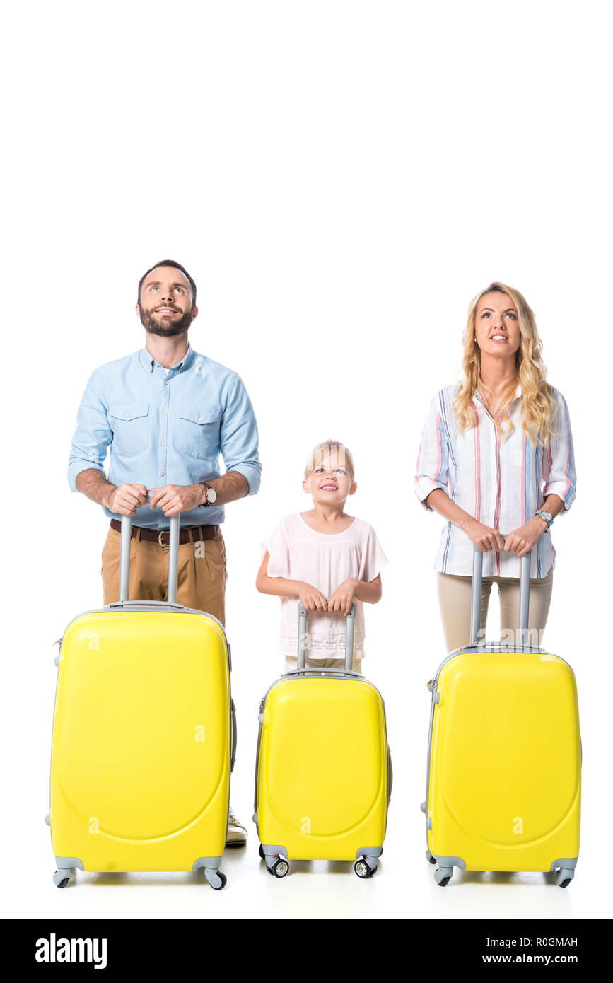 family with yellow travel bags looking up isolated on white Stock Photo