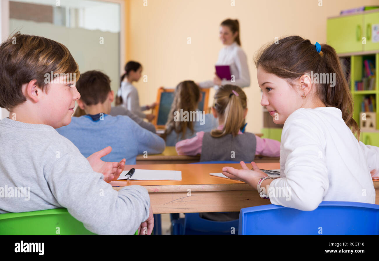 Interaction During Lesson Portrait of children discussing something during lesson in school Stock ...