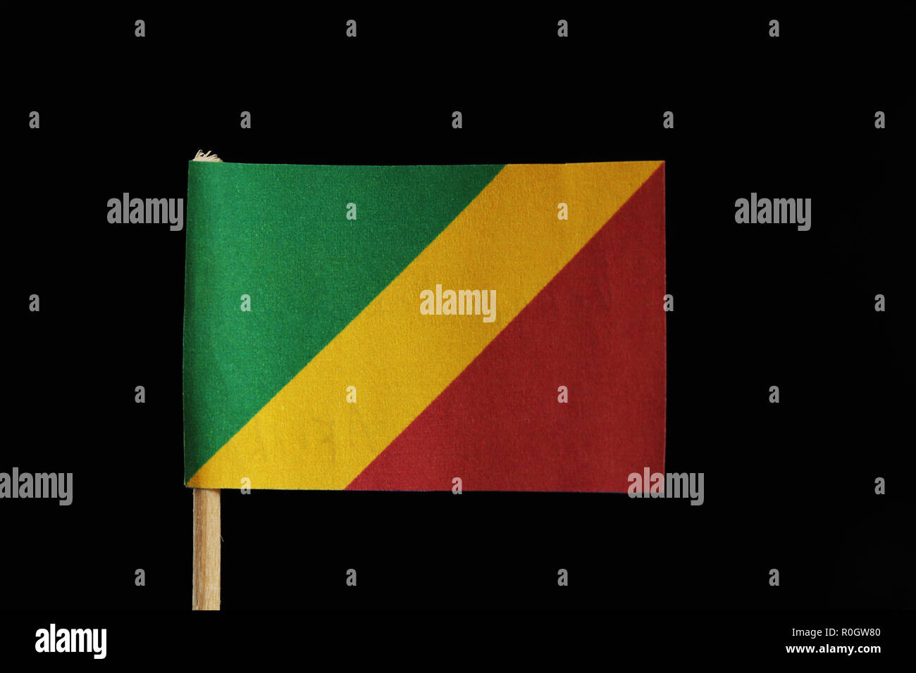 A national flag of the Republic of the Congo on toothpick on black background. Consists of a diagonal tricolour of green, yellow and red radiating fro Stock Photo