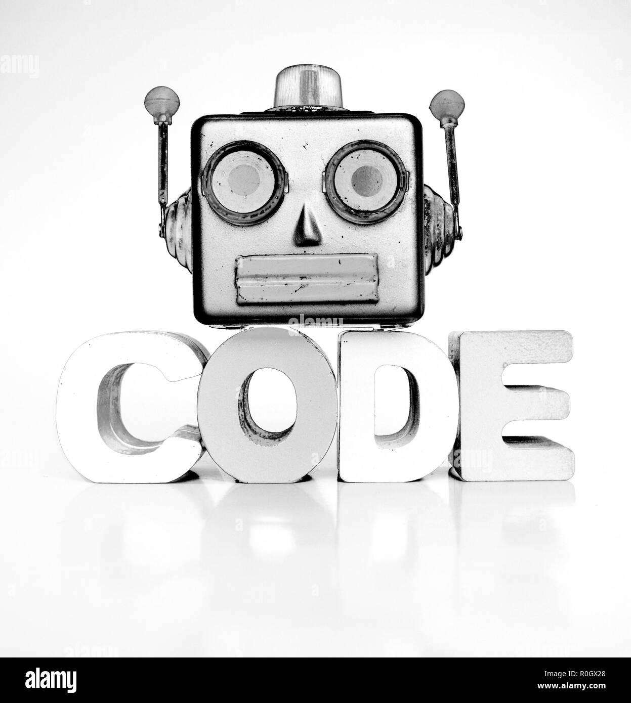 monochrome robots head with the word code  bright image Stock Photo