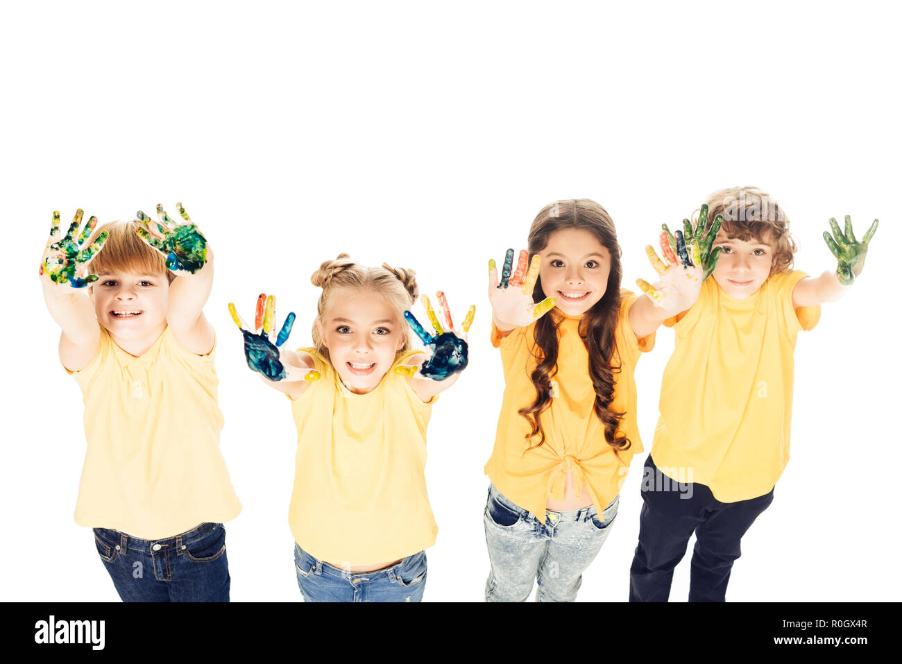 high angle view of adorable happy kids showing hands in paint and ...