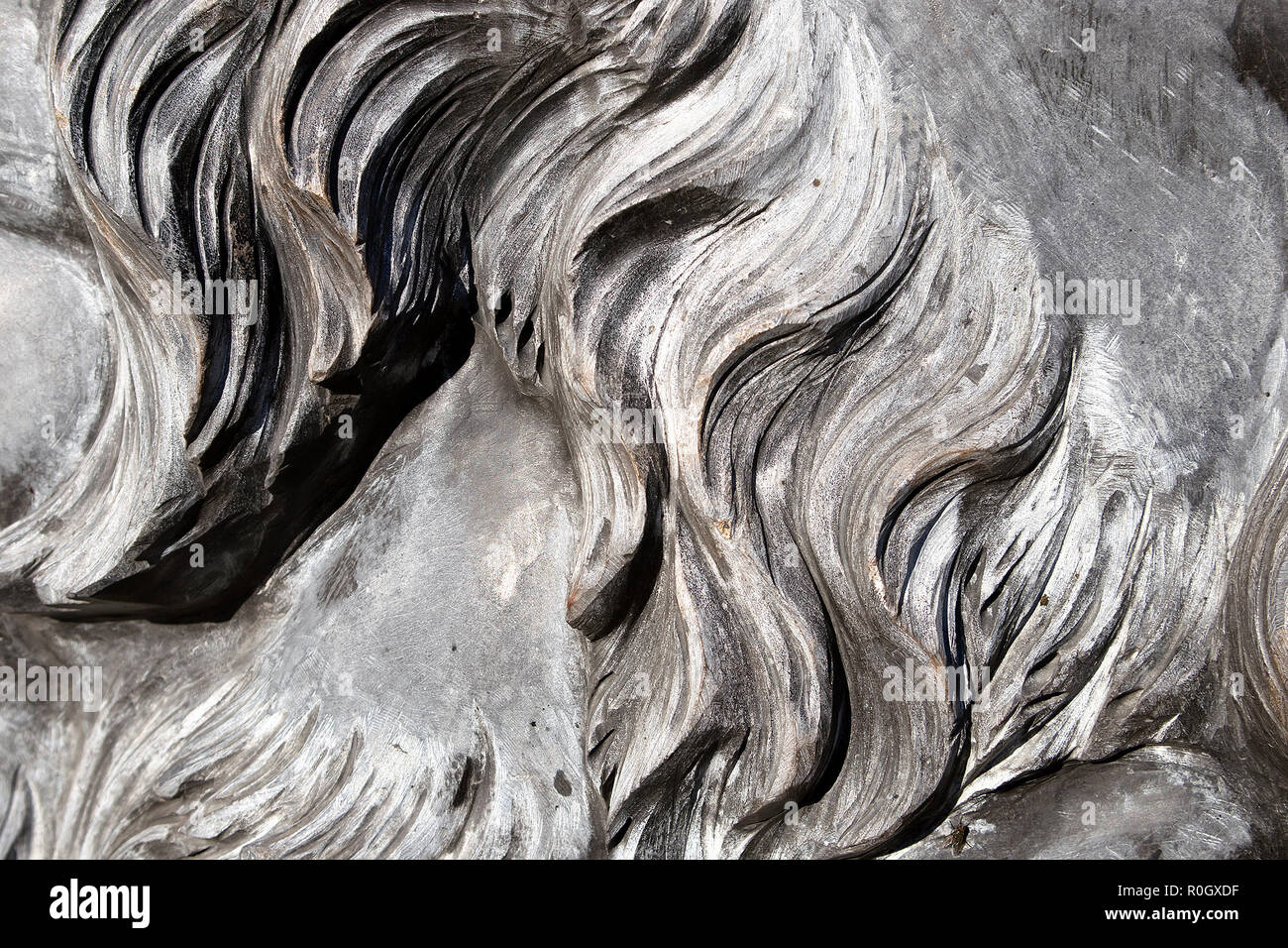 Grey wavy granite lion mane closeup, carved stone background or texture Stock Photo