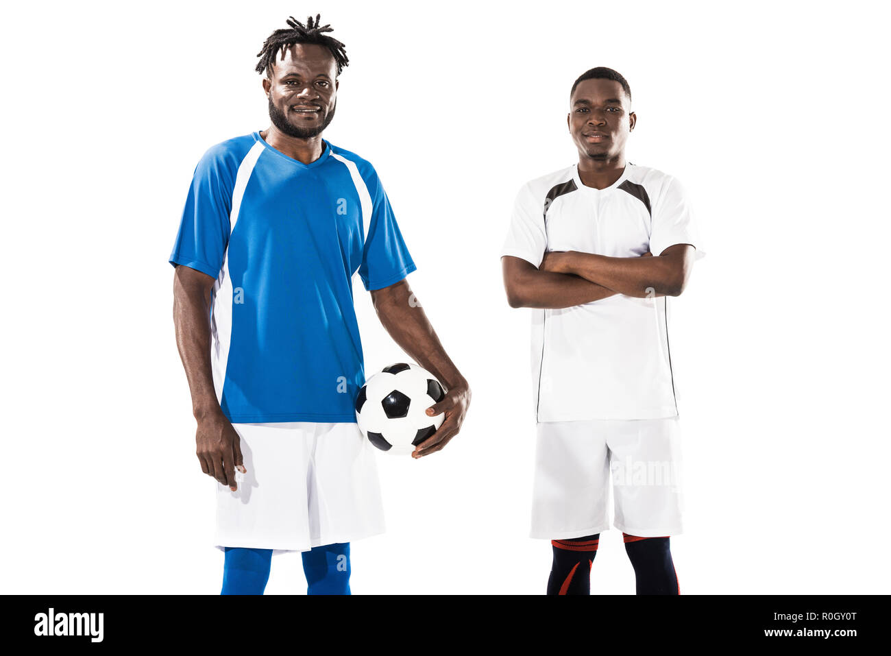athletic young african american soccer players smiling at camera