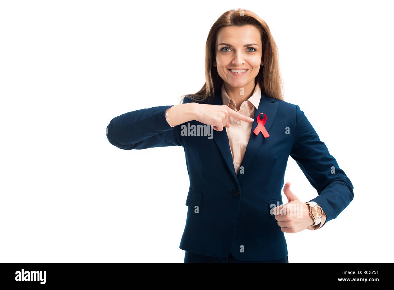 smiling attractive businesswoman pointing on red ribbon and showing ...