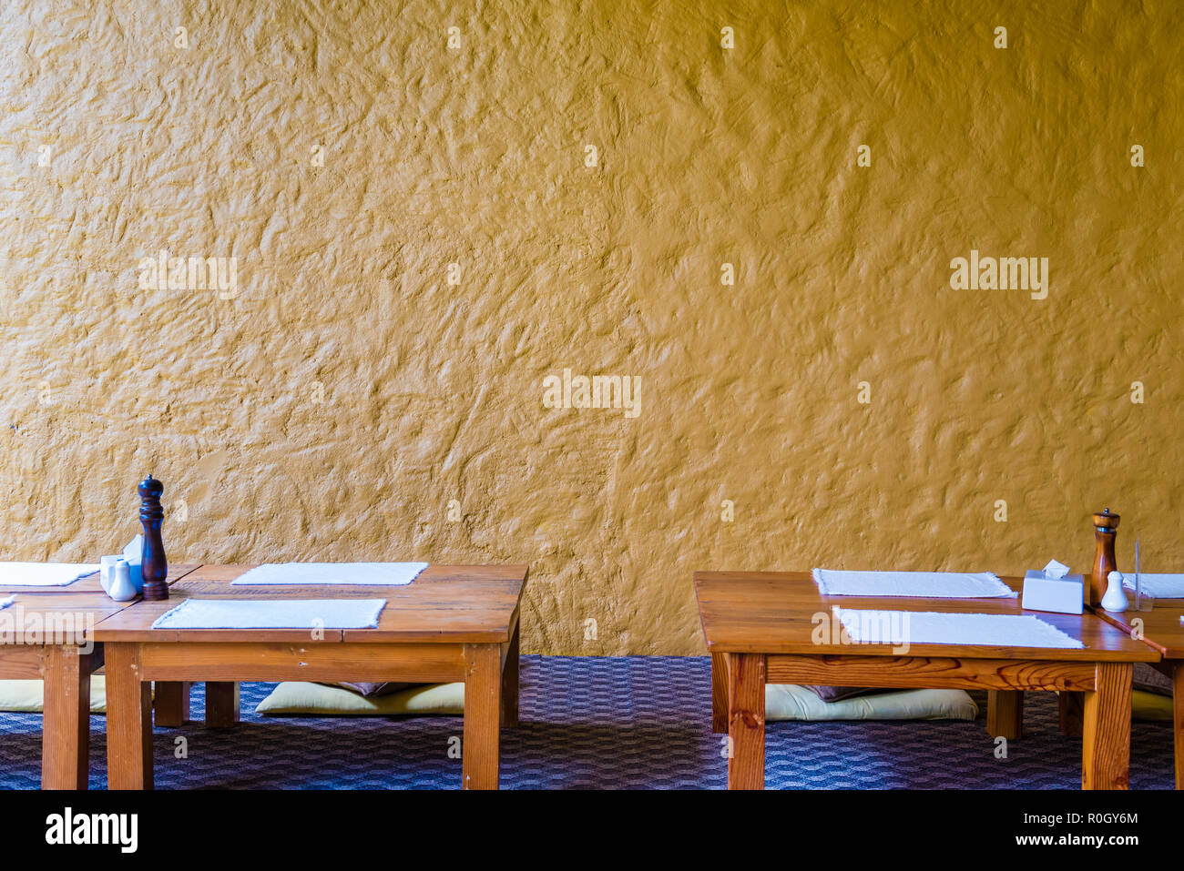 Sit On Floor Low Dinning Table At Restaurant With Yellow Wall In