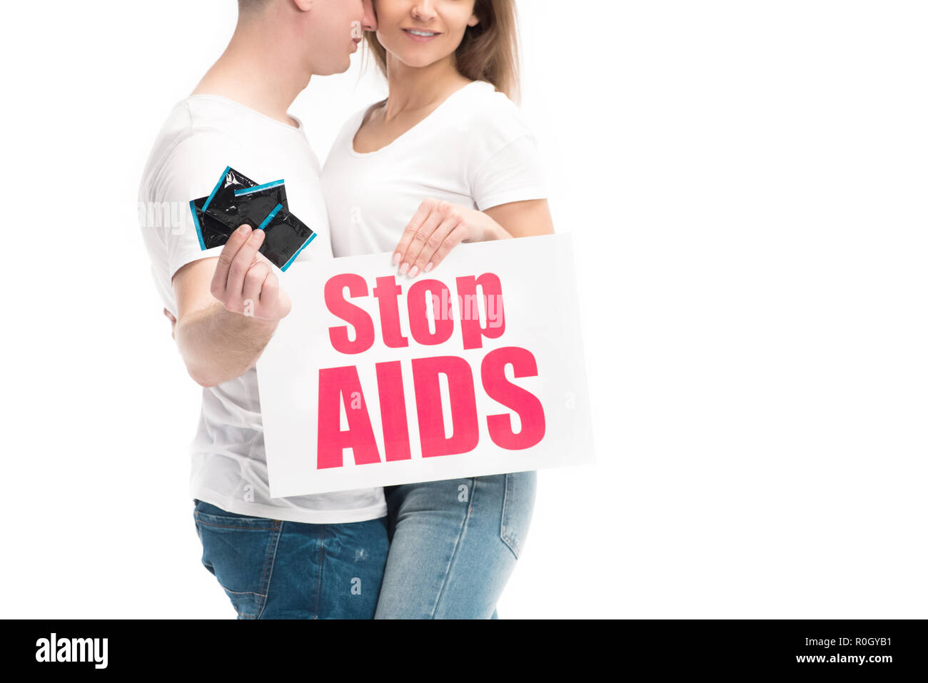 cropped image of boyfriend showing condoms and girlfriend holding card