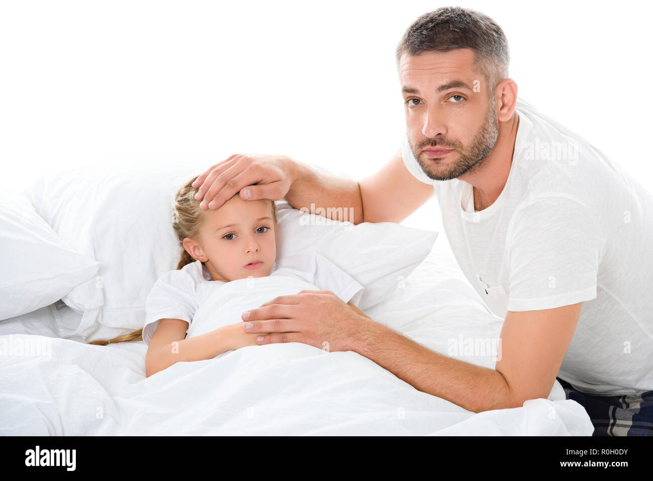 father touching forehead of ill daughter with temperature, isolated on ...