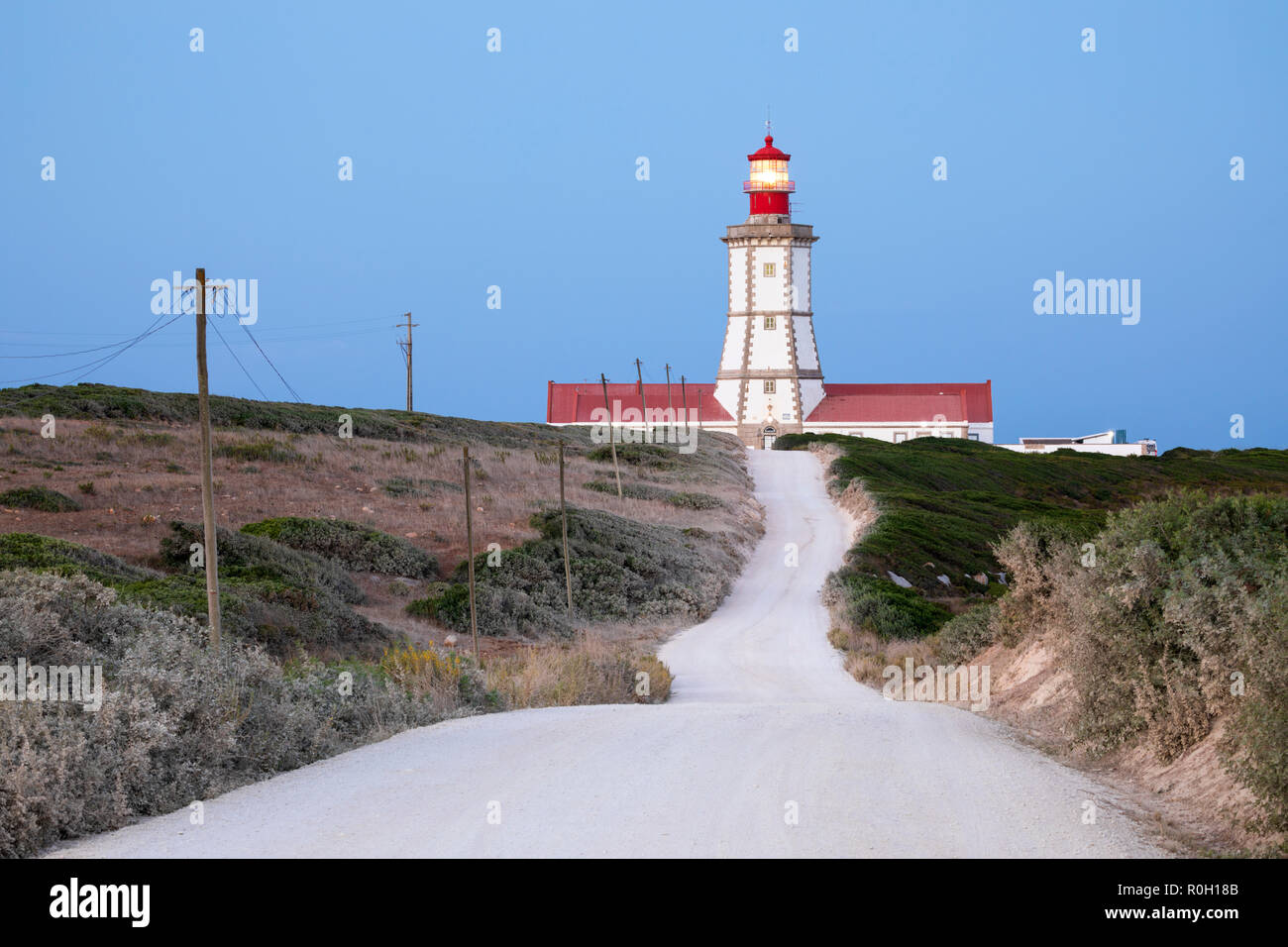 Road leading to Farol do Cabo Espichel lighthouse at dawn, Cabo Espichel, Municipality of Sesimbra, Setubal district, Lisbon region, Portugal, Europe Stock Photo