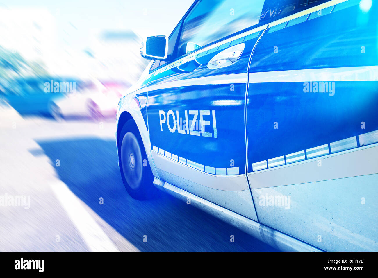 German police car with flashing blue light on street Stock Photo