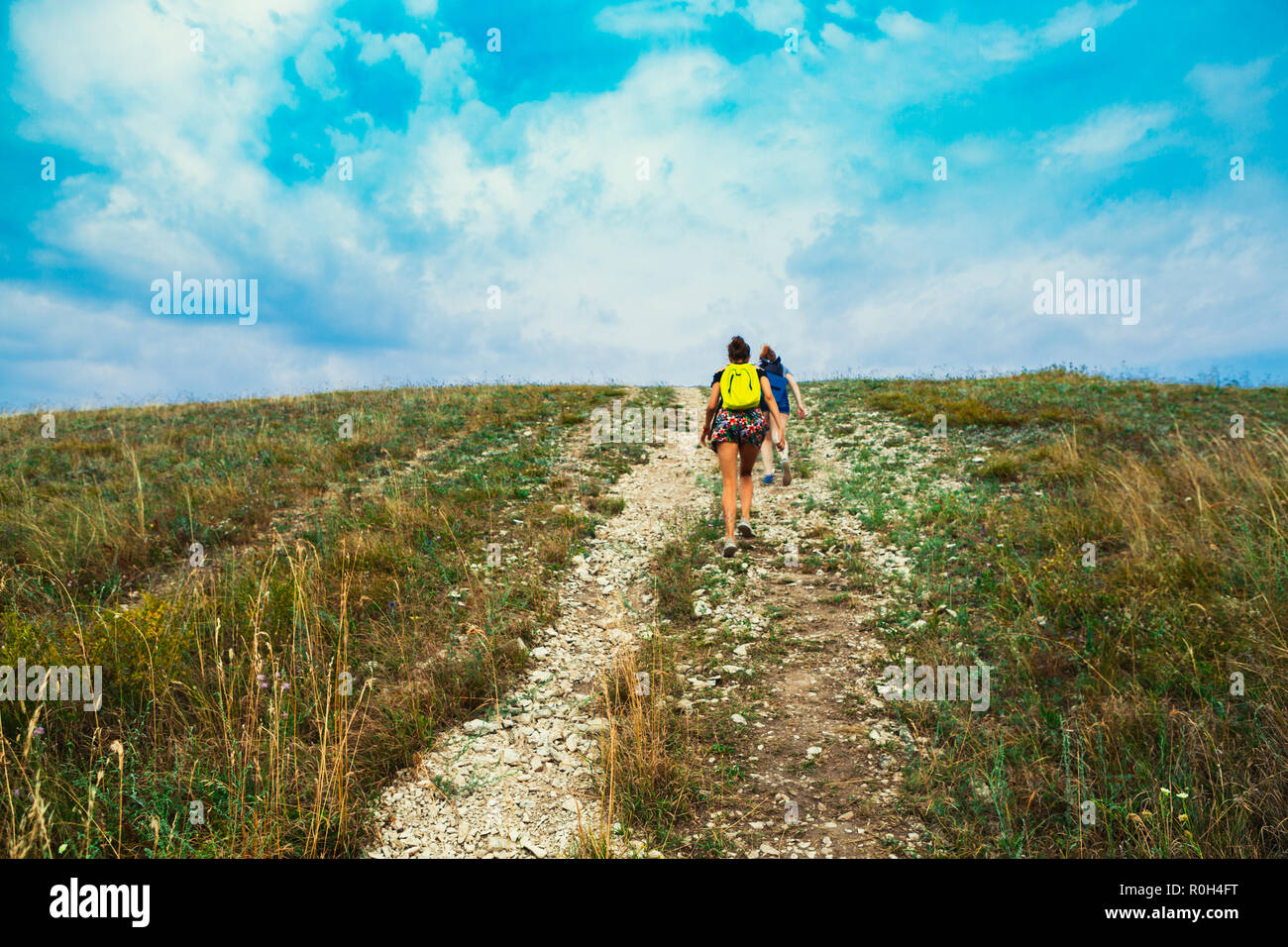Two young girls climb into the mountains Stock Photo - Alamy