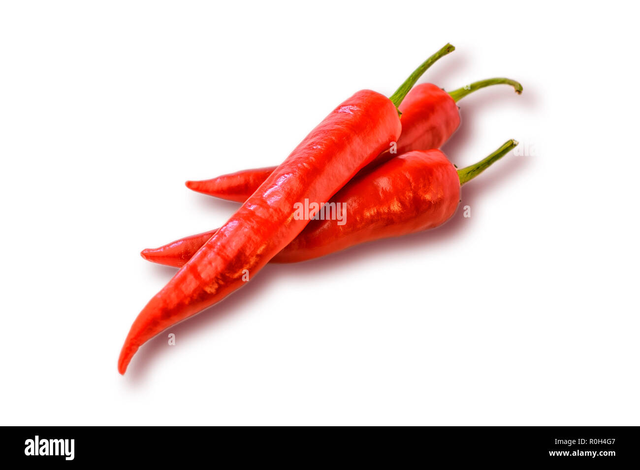 Three red hot chilly pepper on the white background. Fresh spice Stock Photo