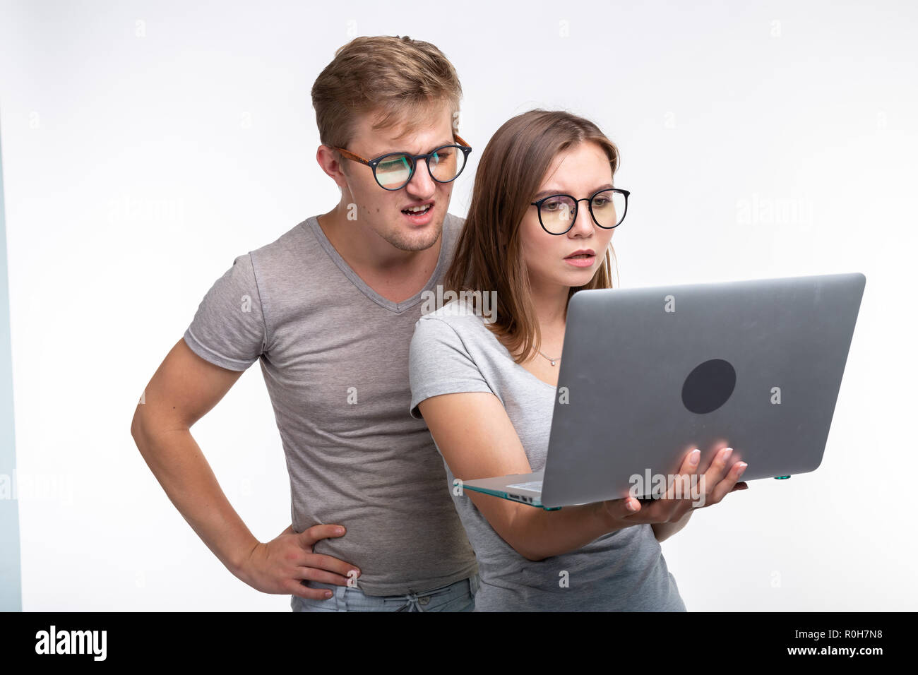People and education concept - Two young student looking in laptop over white background Stock Photo