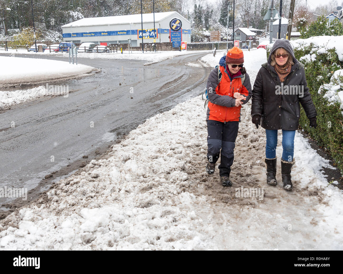 People walking in icy snowy street, Abergavenny, Wales, UK Stock Photo